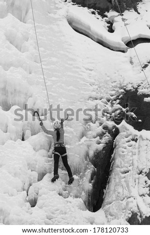 QINGLONG, CHINA - JANUARY 18: Ice climbing enthusiasts use rope, climbing a frozen waterfall, on January 18, 2014, QingLong, hebei province, China.
