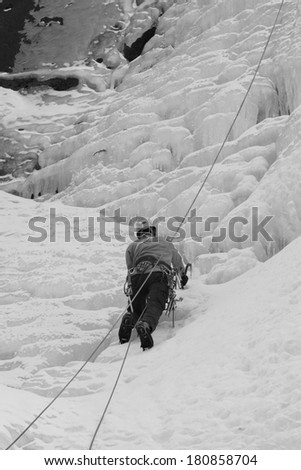 QINGLONG - JANUARY 18: Ice climbing enthusiasts use rope, climbing a frozen waterfall, on January 18, 2014, QingLong, hebei province, China.