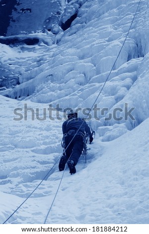 QINGLONG - JANUARY 18: ice climbing enthusiasts use rope, climbing a frozen waterfall, on January 18, 2014, QingLong, hebei province, China.