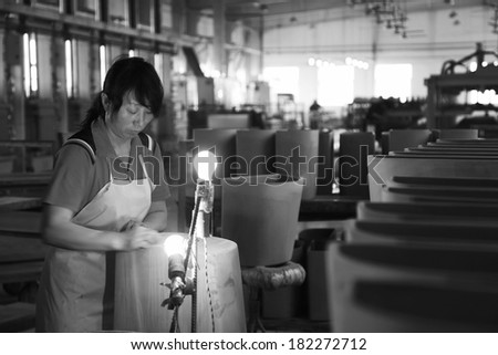 LUANNAN COUNTY - JANUARY 5: Women workers in the production line, in the ZhongTong Ceramics Co., Ltd. January 5, 2014, Luannan county, Hebei Province, China.