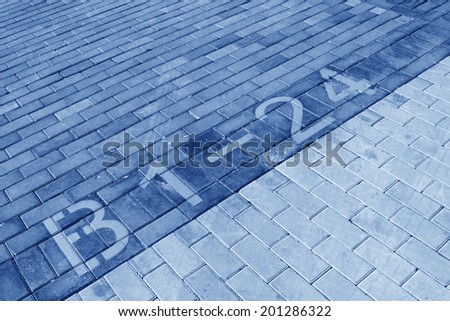 yellow numbers on color cement block, closeup of photo
