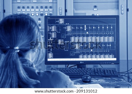 TANGSHAN - JUNE 18: Female technician in view display state in the control room, in a iron and steel co., on June 18, 2014, Tangshan city, Hebei Province, China