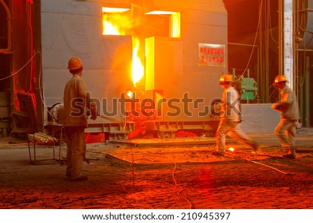 TANGSHAN - JUNE 18: Technical staff check the quality of molten steel, in a iron and steel co., on June 18, 2014, Tangshan city, Hebei Province, China