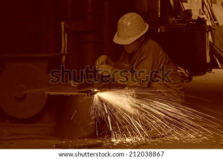 TANGSHAN - JUNE 20: Workers cutting the steel plate in a steel plant, on June 20, 2014, Tangshan city, Hebei Province, China