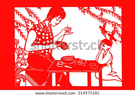 TANGSHAN CITY - AUGUST 28: Chinese paper-cut works on white background in a shop, on august 28, 2014, Tangshan City, Hebei Province, China