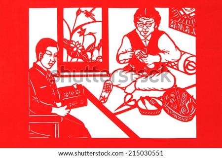 TANGSHAN CITY - AUGUST 28: Chinese paper-cut works on white background in a shop, on august 28, 2014, Tangshan City, Hebei Province, China