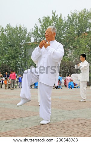 LUANNAN COUNTY - SEPTEMBER 20: Old men boxing performance in a square on September 20, 2014, Luannan county, Hebei Province, China