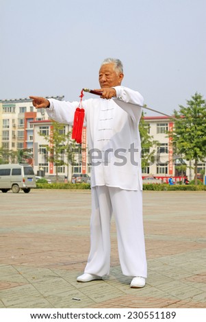 LUANNAN COUNTY - SEPTEMBER 20: Old men Fencing performance in a square on September 20, 2014, Luannan county, Hebei Province, China