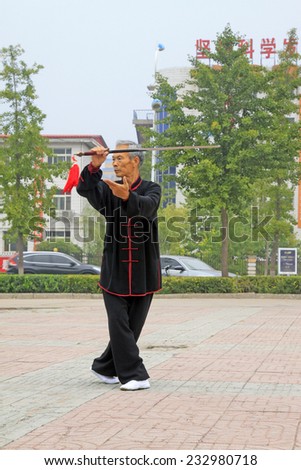 LUANNAN COUNTY - SEPTEMBER 20: Old man Fencing performance in a square on September 20, 2014, Luannan county, Hebei Province, China