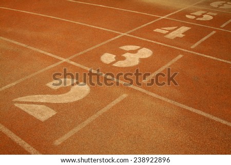 green number on plastic runway in a sports ground in a middle school
