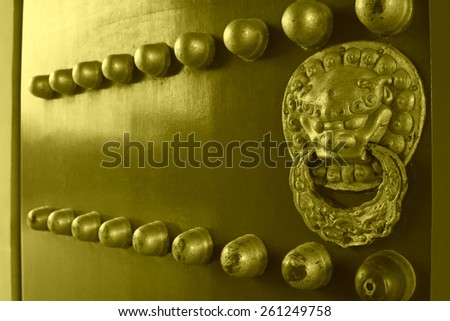 Bronze decoration and copper nail on the red palace, in the temple of heaven park, on January 17, 2014, Beijing, China.