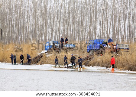 LUANNAN COUNTY - JANUARY 24: Farmers transport ice in the winter on January 24, 2015, Luannan County, Hebei Province, China