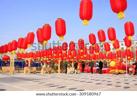 LUANNAN COUNTY - MARCH 5: On the Lantern Festival Day, People under the red lanterns in a park, March 5, 2015, luannan county, hebei province, China