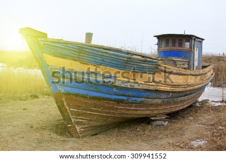 Broken boat on land, closeup of photo