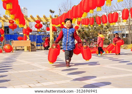 LUANNAN COUNTY - MARCH 5: On the Lantern Festival Day, Children playing with red lanterns in a park, March 5, 2015, luannan county, hebei province, China