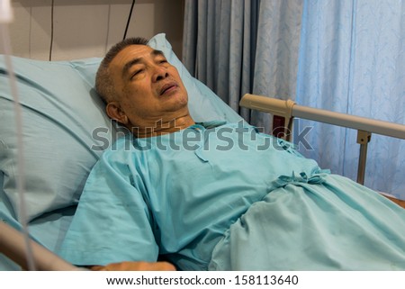 Old man patient sleeping in hospital bed