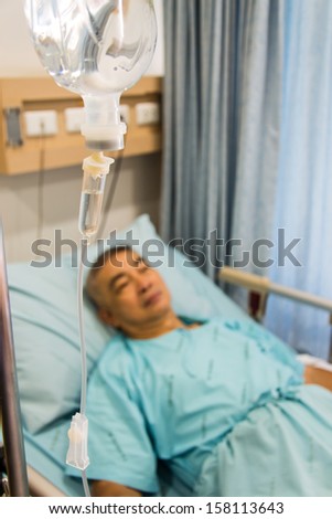 Old man patient sleeping in hospital bed
