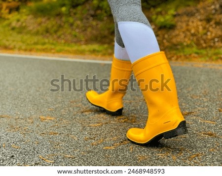 Image, Stock Photo unrecognizable woman wearing yellow raincoat preparing hammock to relax. Camping outdoors. autumn season