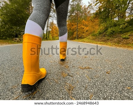 Similar – Image, Stock Photo unrecognizable woman wearing yellow raincoat preparing hammock to relax. Camping outdoors. autumn season