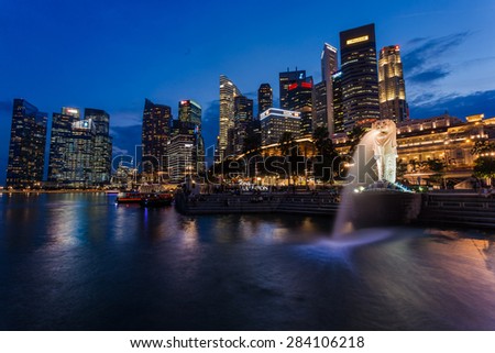 SINGAPORE - MARCH 2, 2015: Sunset scene of Singapore skyline with merlion on march 2, 2015. Merlion fountain is one of the most famous tourist attraction in Singapore.