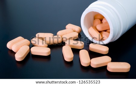 Tablets on black background. able to use for demonstrate the side effect of drug.