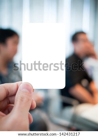Hand holding card in the serious meeting. Able to put any message in there such as \