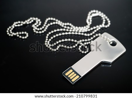 Macro image of a key-shaped USB drive in concept of technology security