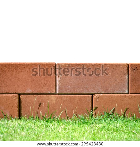 Brick layers on green grass leaving white space on top