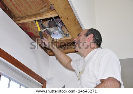 man fixing an interior ceiling light