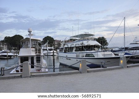 Boats docked in Harbour Town marina at dusk.  The marina is located on Hilton Head Island in South Carolina.