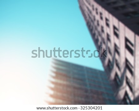 View at the two skyscrapers with blur effect and sun flare