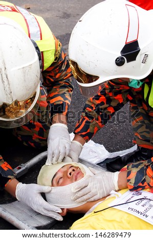 SEREMBAN, MALAYSIA - APRIL 8: Firefighter (EMRS) Emergency Medical Rescue Services Team in action during DMEX exercise at Negeri Sembilan on April 8, 2012 Seremban, Malaysia