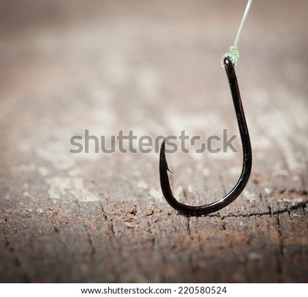 fish hook on wood background