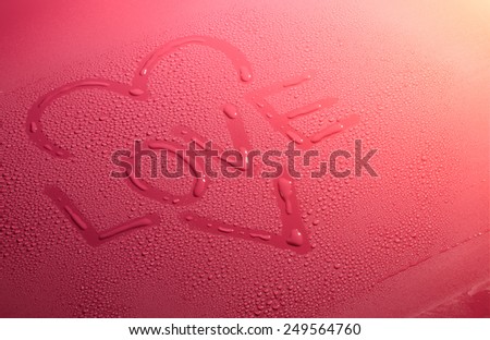 Valentine Day Love heart made by water bubbles on a red background