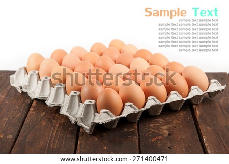 Eggs in paper tray on wood