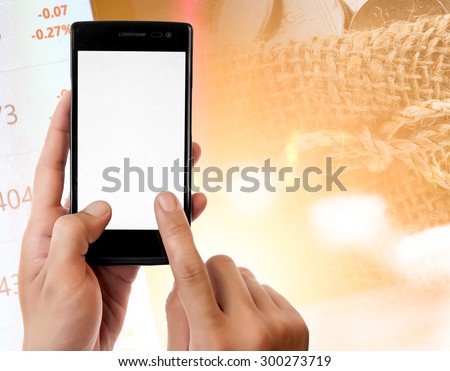 Hand holding smart phone on Money and the graph them,online banking make money concept.