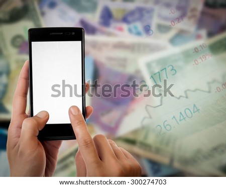 Hand holding smart phone on Money and the graph them,online banking make money concept.