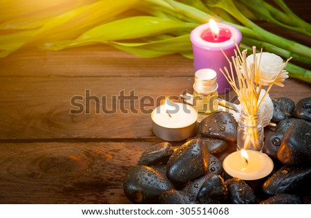 zen basalt stones, lavender candles on wooden,dark background,,Selective focus on candle