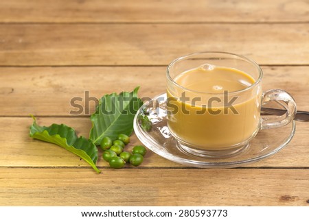 Coffee with cream and coffee leaves