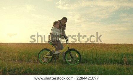 Similar – Image, Stock Photo A young mother teaches her little daughter to draw with colored pencils. Time together, creativity, education. Side view