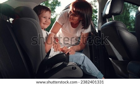 Similar – Image, Stock Photo Mom puts a child a mask and escorts to school or kindergarten. A boy with a masked backpack during a coronavirus. Side view