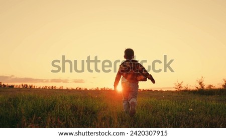 Similar – Image, Stock Photo Little boy walking across meadow, father in the background