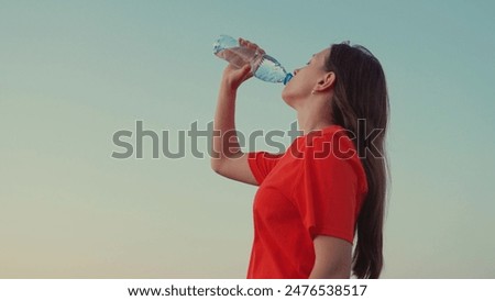 Similar – Image, Stock Photo Young woman drinking water while training on mat at home