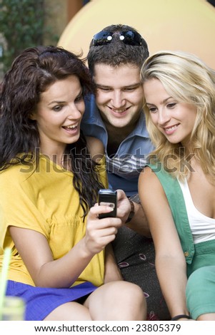 Group of friends reading message on a mobile phone