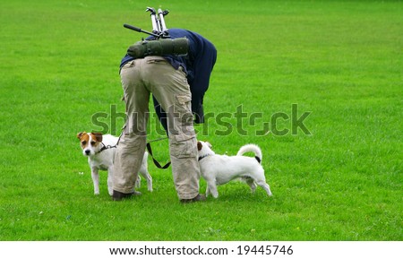 Happy dogs in grass with photographer
