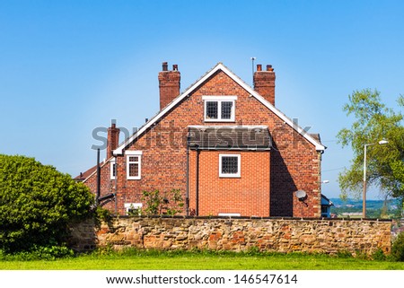 Typical English house on blue sky