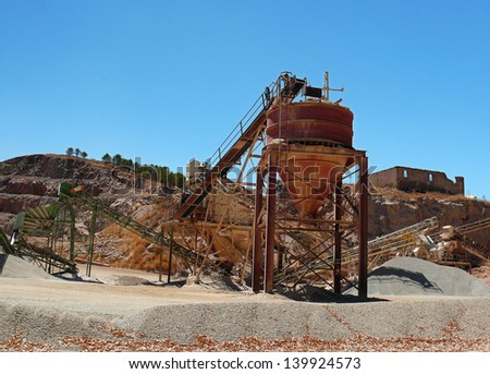machines of a gravel pit and the destruction of a mountain