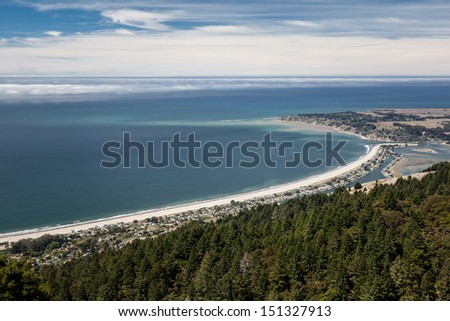 Seen from hiking trails in the hills, the gentle curve of Stinson Beach, just north of San Francisco, California, stretches northward on a sunny day.