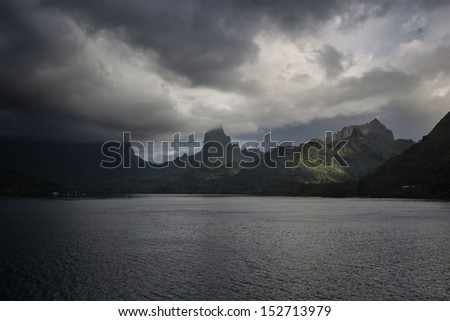 Dark clouds appear over the volcanic island of Moorea in French Polynesia. This south Pacific tropical island is one of the most beautiful in the world.