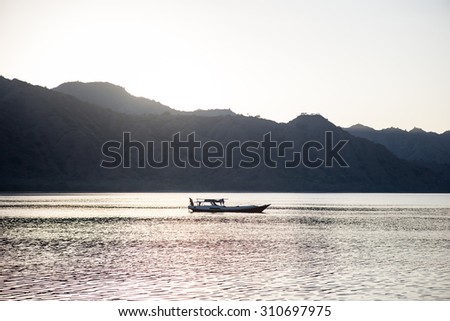A small fishing vessel lies at anchor in Komodo National Park, Indonesia. This fascinating region, part of the Ring of Fire, is home to an amazing diversity of life both above and below the waterline.